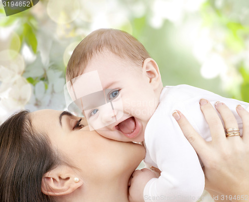 Image of happy laughing baby playing with mother