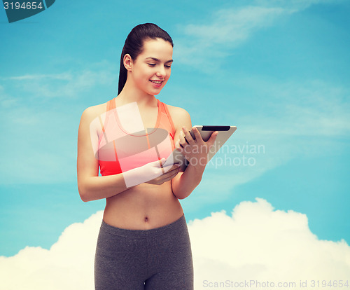 Image of sporty woman with tablet pc computer