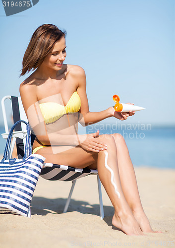 Image of girl sunbathing on the beach chair