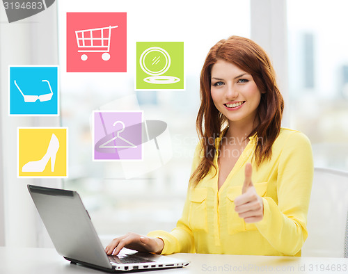 Image of smiling woman with laptop shopping online at home