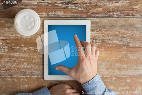 Image of close up of male hands with tablet pc and coffee