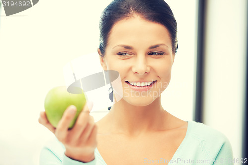 Image of lovely housewife with green apple