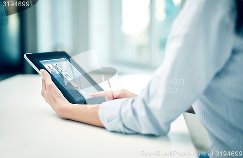 Image of close up of woman hands with tablet pc at office