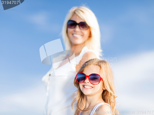 Image of mother and child in sunglasses