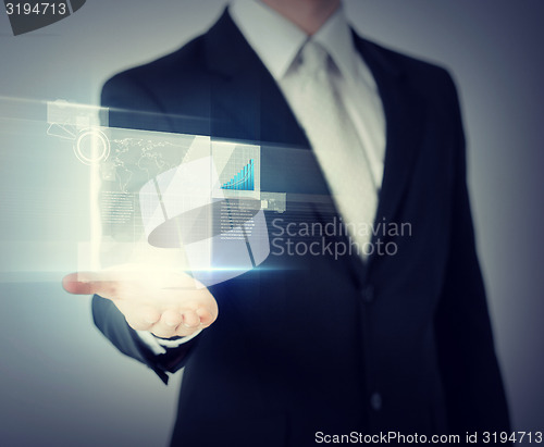 Image of businessman hand showing chart on virtual screen