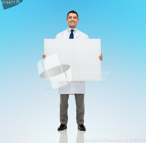 Image of smiling male doctor holding white blank board