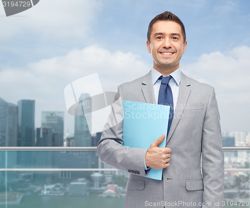 Image of happy businessman holding folder