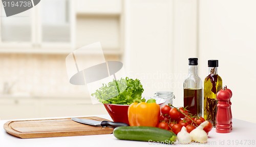 Image of vegetables, spices and kitchenware on table