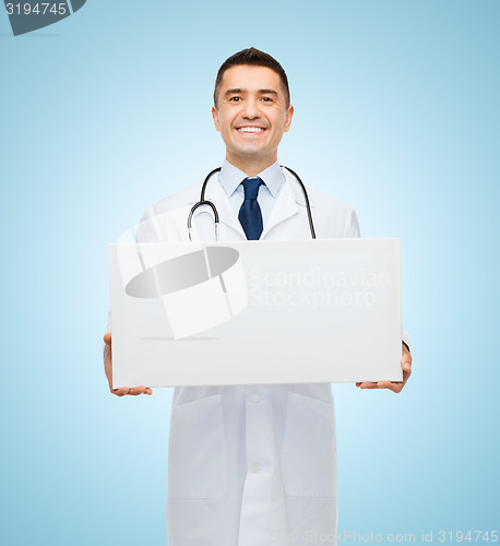 Image of smiling male doctor holding white blank board