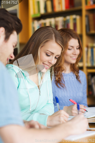 Image of students preparing to exam and writing in library