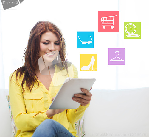 Image of smiling woman with tablet pc computer at home