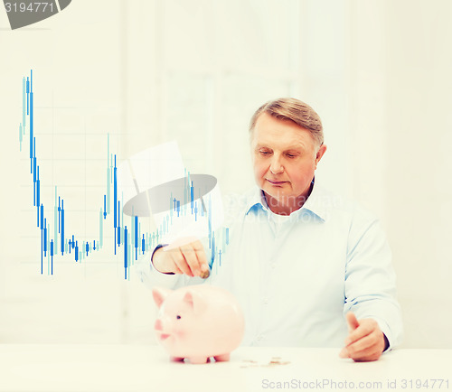 Image of old man putting coin into big piggy bank