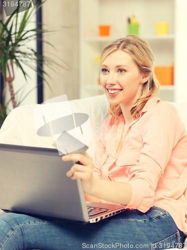 Image of happy woman with laptop computer and credit card