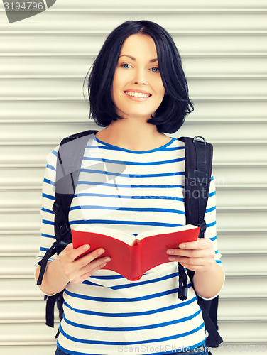 Image of woman with bag and book