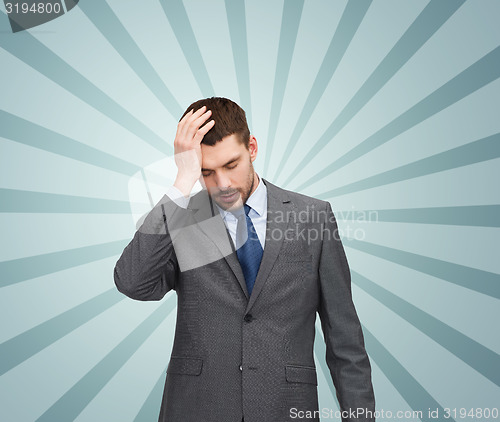 Image of young businessman having headache