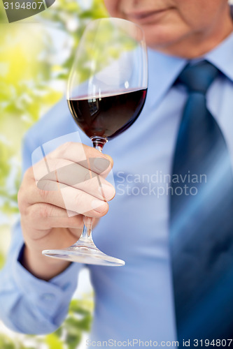 Image of close up of senior man drinking wine from glass