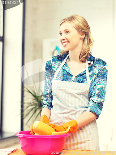 Image of housewife washing dish at the kitchen