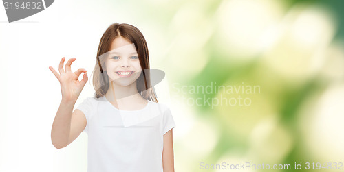 Image of smiling little girl in white blank t-shirt