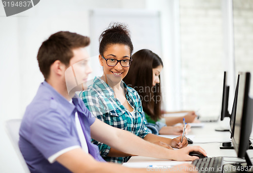 Image of african student with computer studying at school