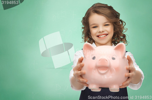 Image of happy girl holding piggy bank 