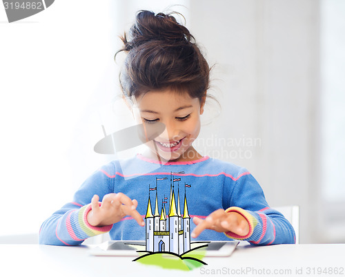 Image of happy little girl with tablet pc at home