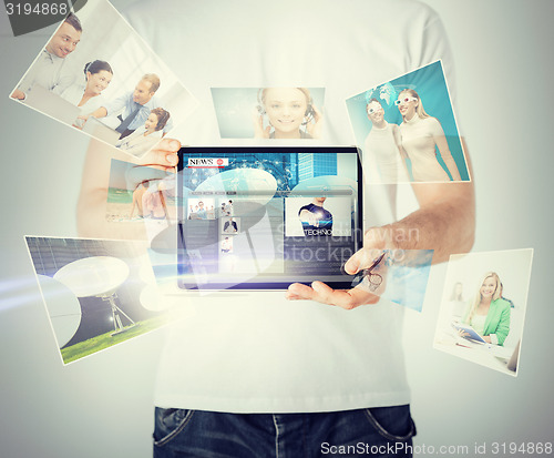 Image of man showing tablet pc with news