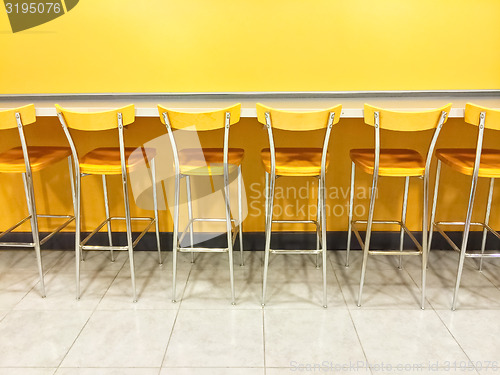 Image of Raw of yellow chairs in a cafeteria