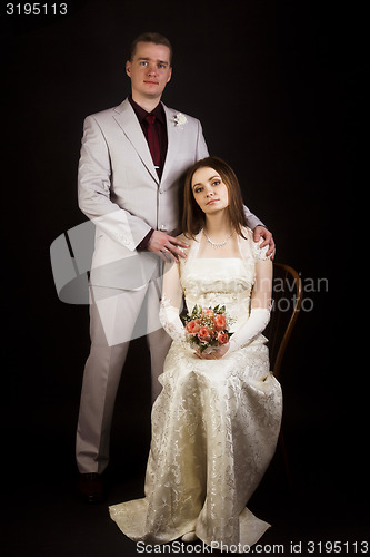 Image of Wedding photo. Young beautiful couple on a black background.