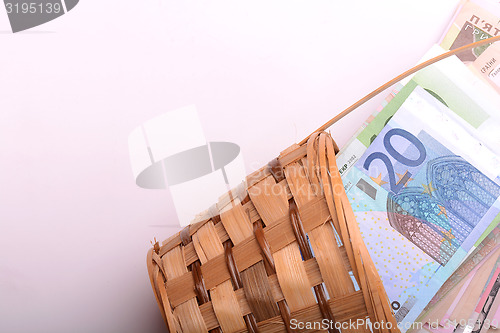 Image of european money on wooden basket, dollars, euro