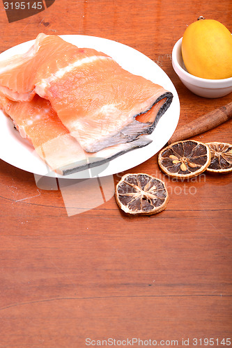 Image of Slice of red fish salmon with fruits and cinnamon