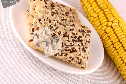 Image of sweet cake on white plate and corn