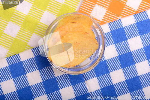 Image of Potato chips on glass bowl, close up