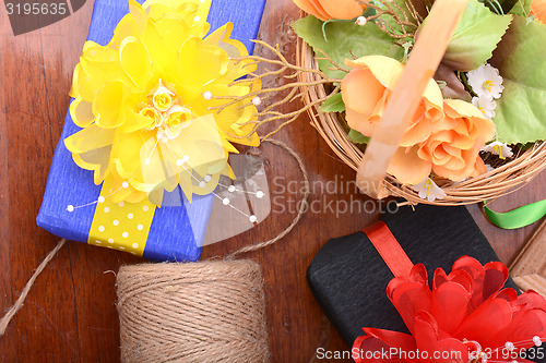 Image of gift box, flowers and old thread