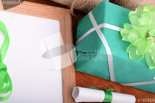 Image of green gift box and wooden board, holiday concept