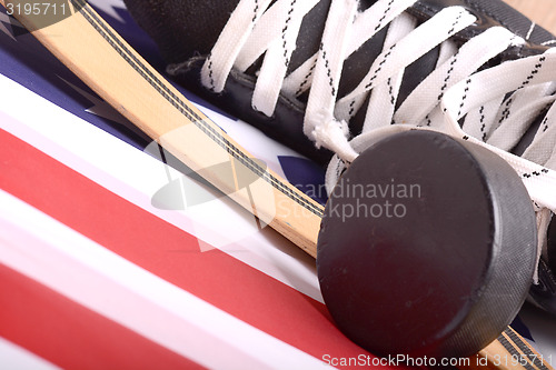 Image of Puck, skates and hockey stick of the American flag