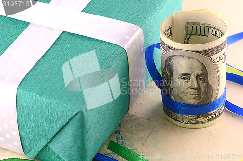 Image of american money dollars and green gift box