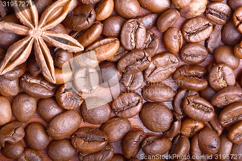 Image of Chocolate muffin, coffee beans, cinnamon, star anise on sacking background.
