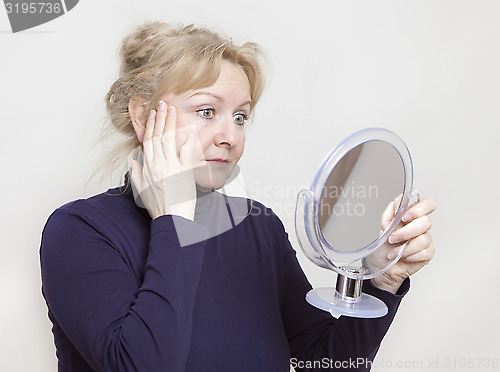 Image of Senior looking in mirror