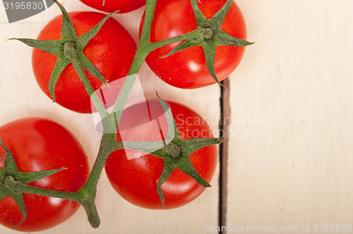 Image of fresh cherry tomatoes on a cluster