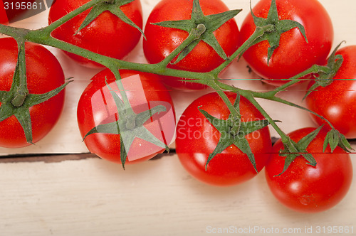 Image of fresh cherry tomatoes on a cluster