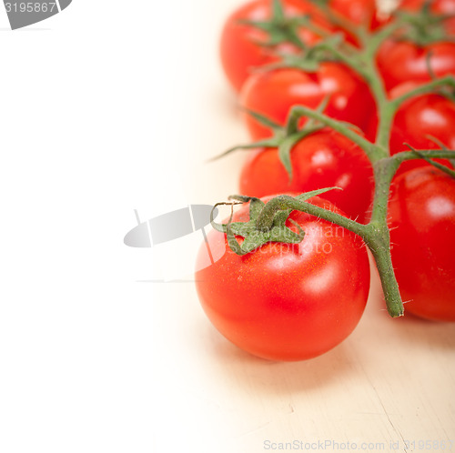 Image of fresh cherry tomatoes on a cluster