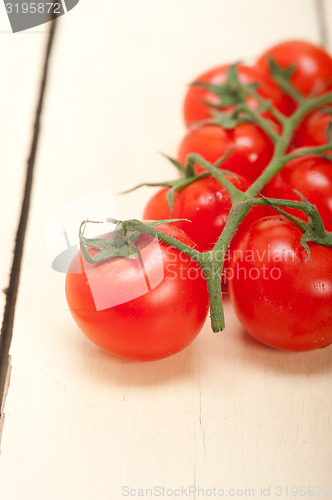 Image of fresh cherry tomatoes on a cluster