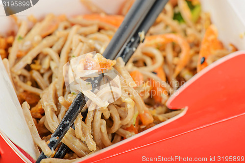 Image of Noodles in red take away container
