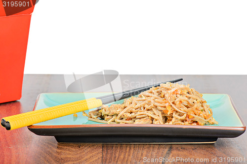 Image of Meat and noodles in red take away container