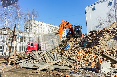 Image of Excavator works garbage from demolished house