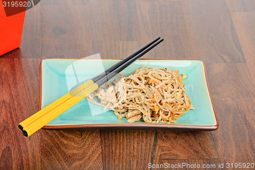 Image of Meat and noodles in red take away container