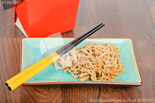 Image of Meat and noodles in red take away container