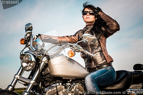 Image of Biker girl on a motorcycle