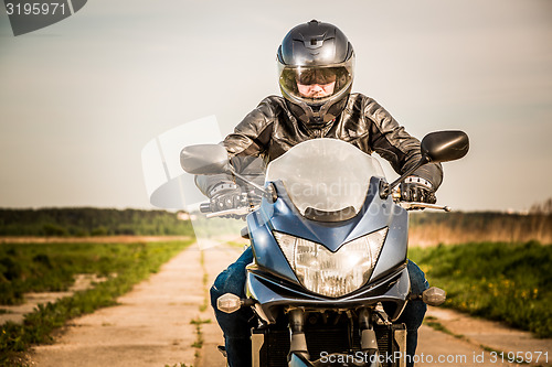 Image of Biker racing on the road