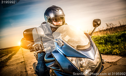 Image of Biker racing on the road